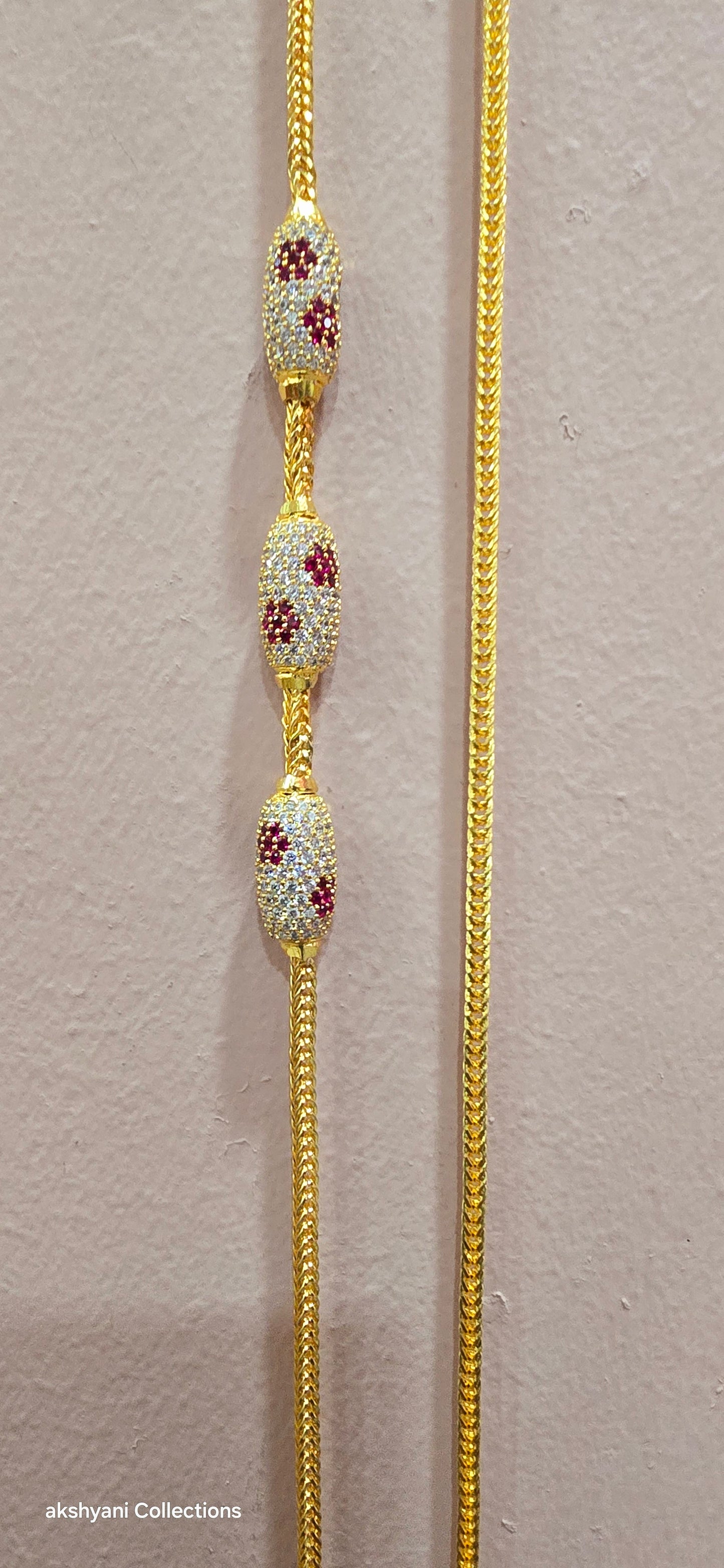Ruby red with white pawprint mossanite stones Dailywear type thalikodi.  Not 916 gold