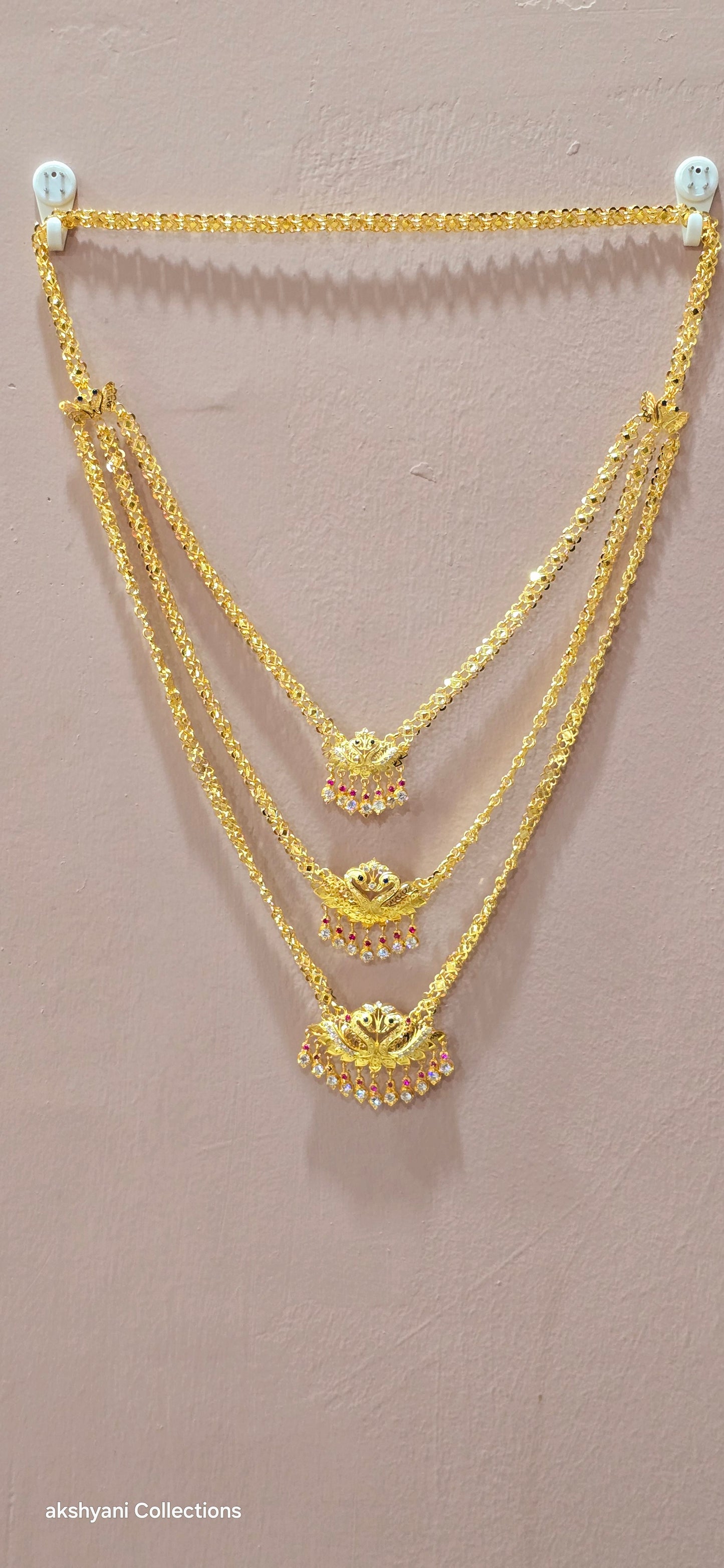 3 layer pendent chain not 916 gold. 28 inches length with decked peacock brooch. Code 808A.