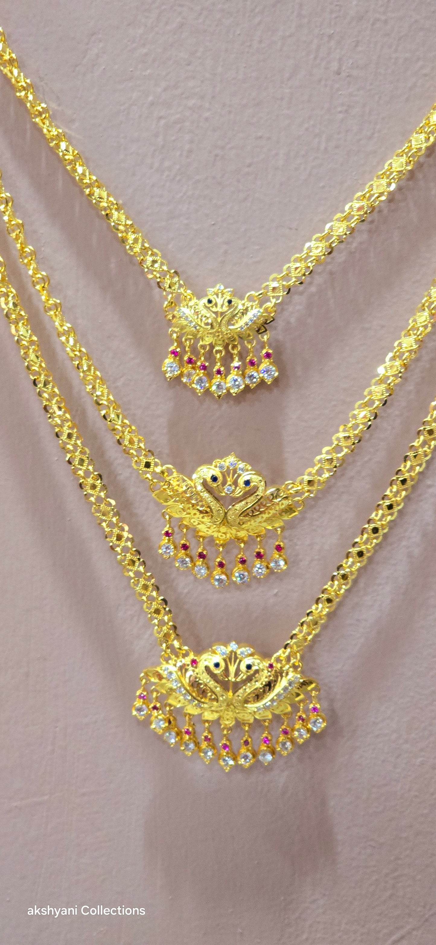 3 layer pendent chain not 916 gold. 28 inches length with decked peacock brooch. Code 808A.