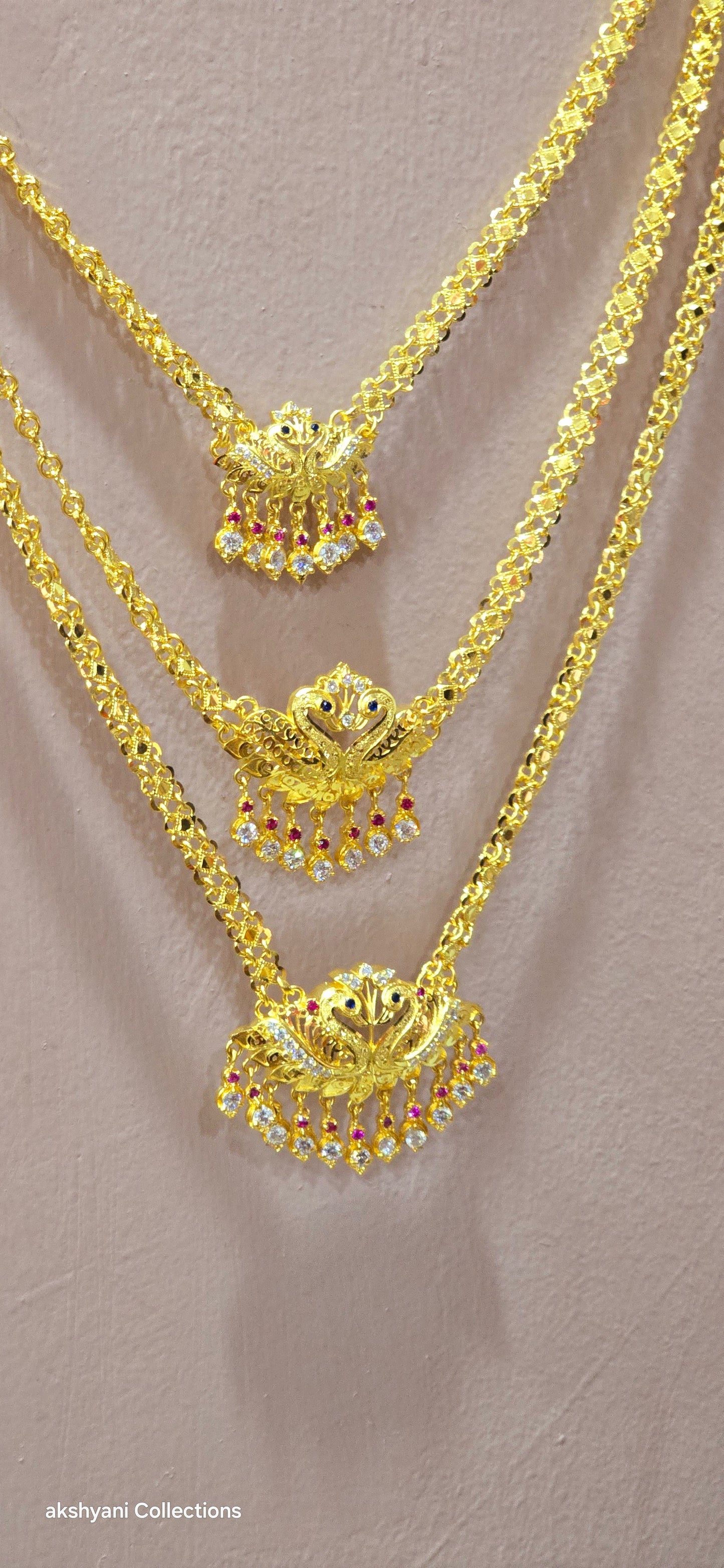 3 layer pendent chain not 916 gold. 28 inches length with decked peacock brooch. Code 808A.