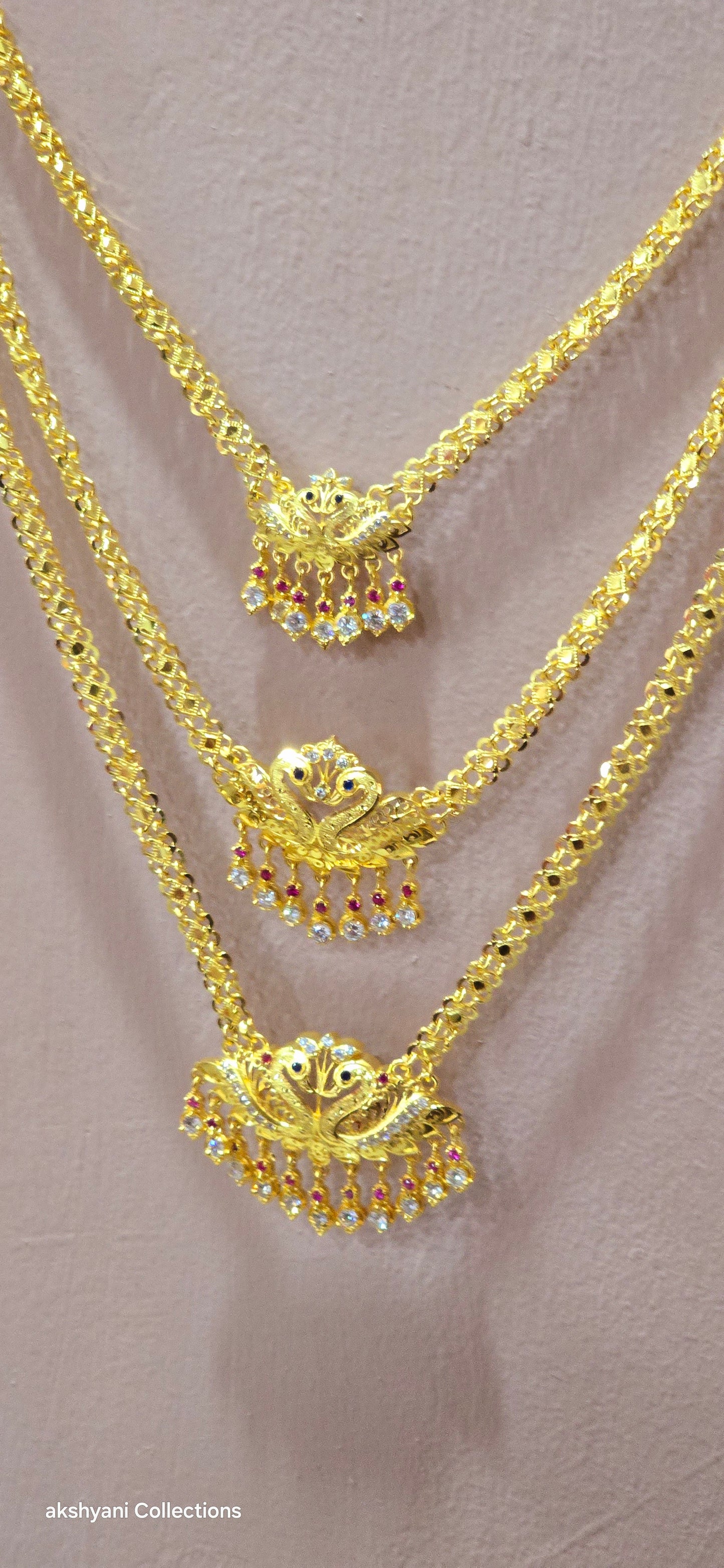 3 layer pendent chain not 916 gold. 28 inches length with decked peacock brooch. Code 808A.