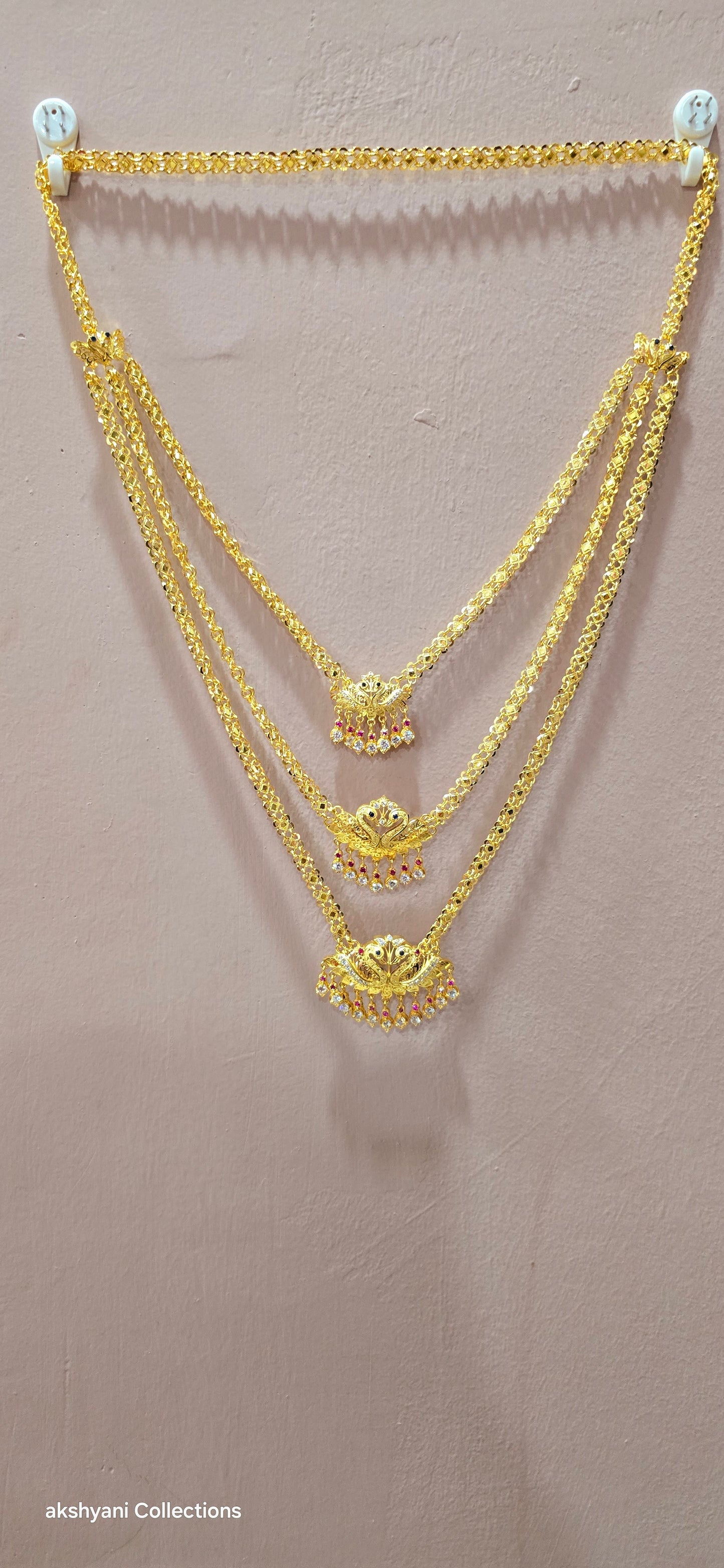 3 layer pendent chain not 916 gold. 28 inches length with decked peacock brooch. Code 808A.