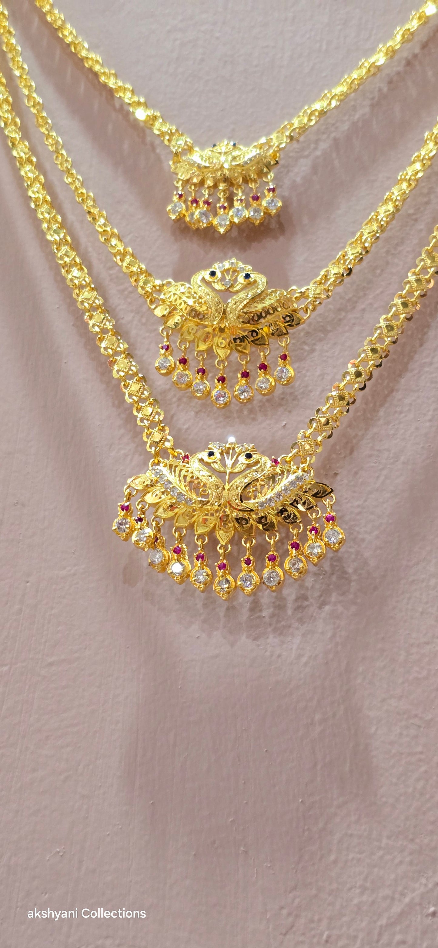 3 layer pendent chain not 916 gold. 28 inches length with decked peacock brooch. Code 808A.
