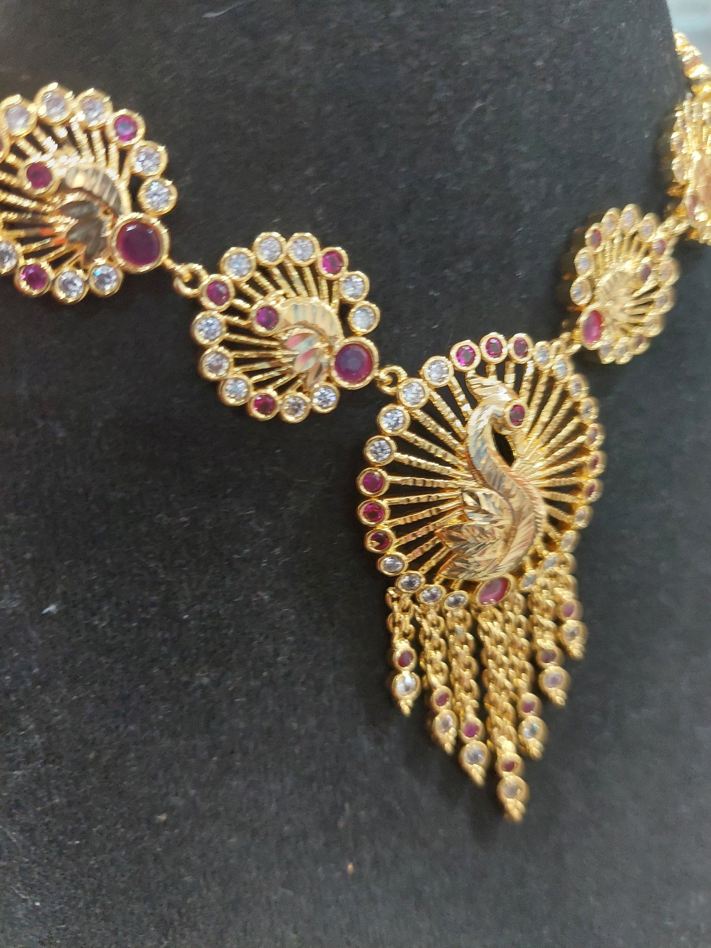 Micron plating peacock necklace with rings behind to adjust. Not 916 gold.