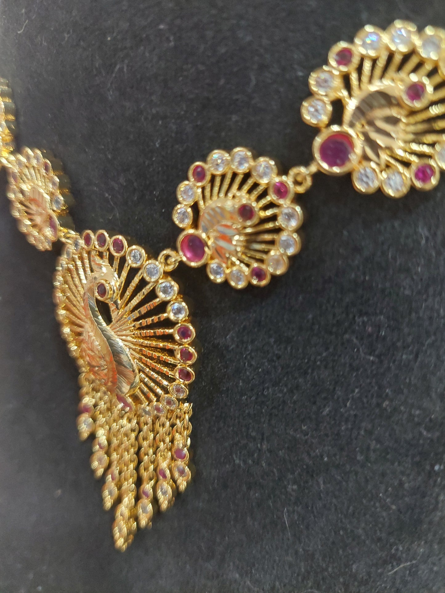 Micron plating peacock necklace with rings behind to adjust. Not 916 gold.