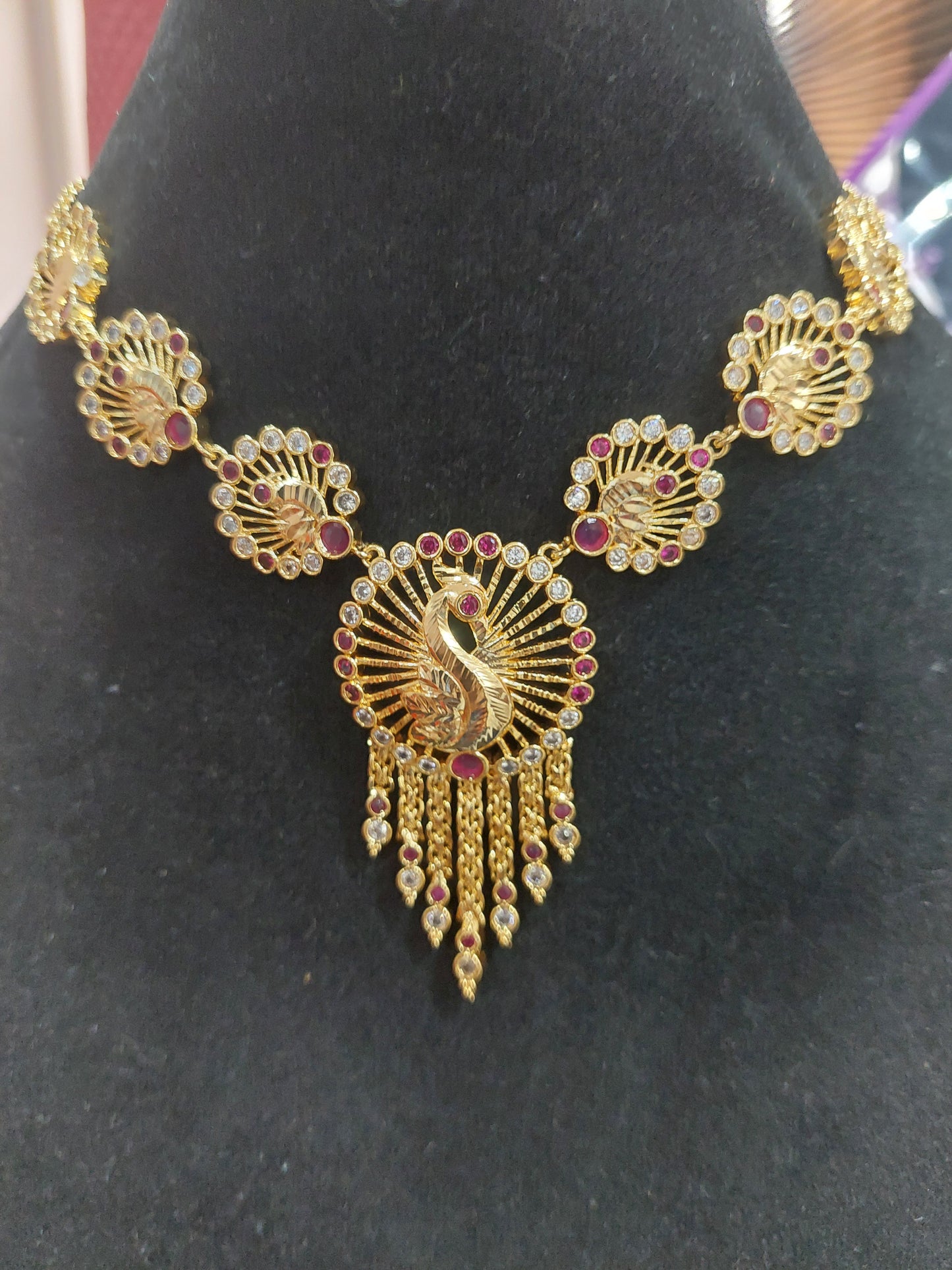 Micron plating peacock necklace with rings behind to adjust. Not 916 gold.