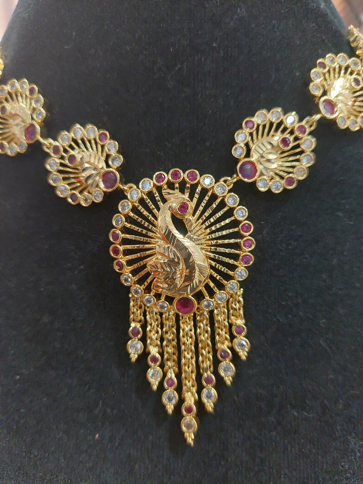 Micron plating peacock necklace with rings behind to adjust. Not 916 gold.