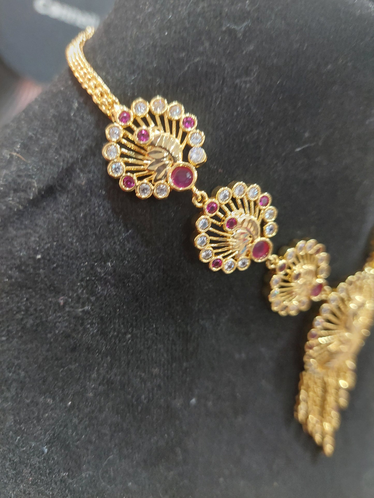 Micron plating peacock necklace with rings behind to adjust. Not 916 gold.