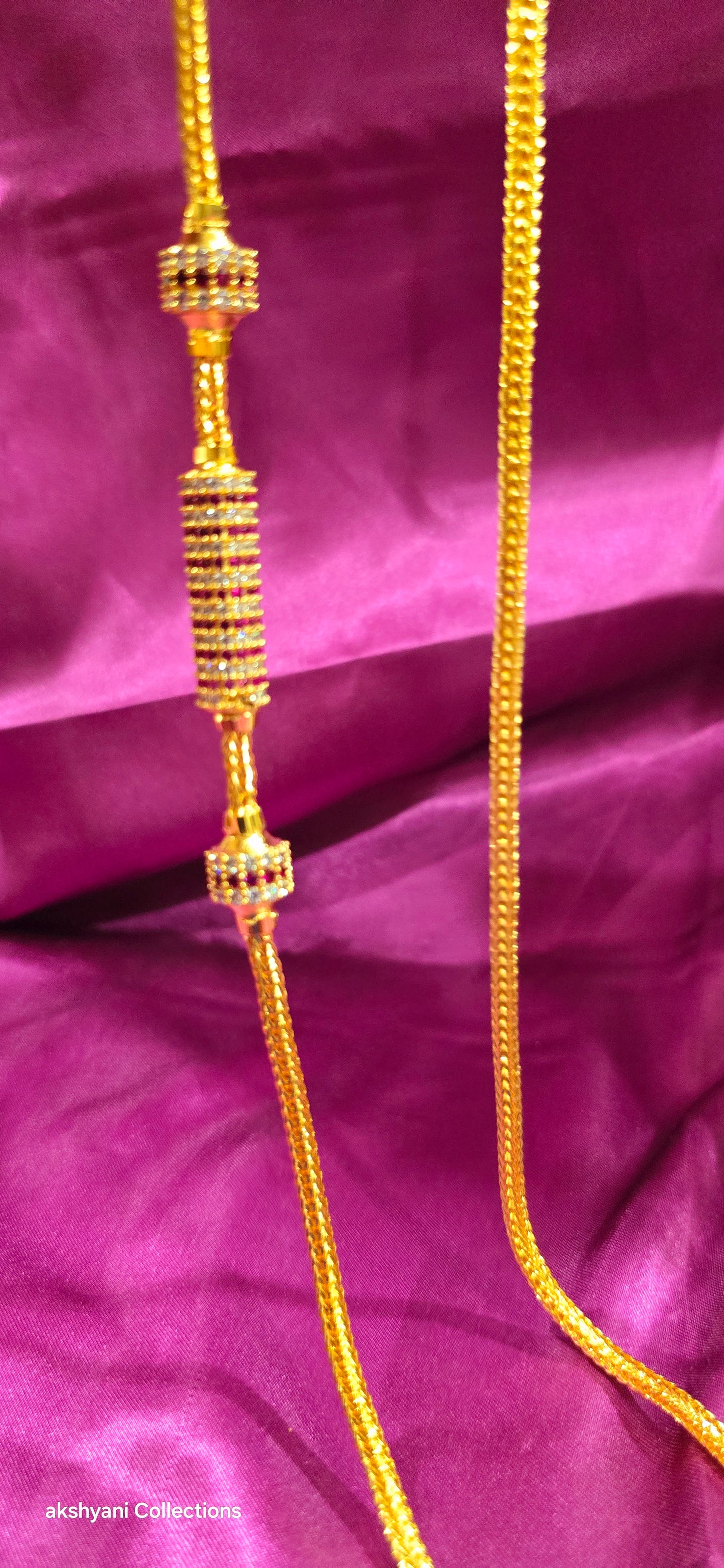 Ruby red Functionwear type thalikodi.  Not 916 gold