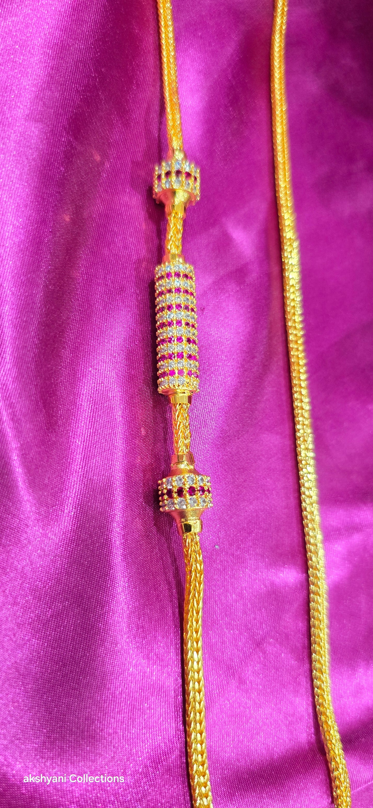 Ruby red Functionwear type thalikodi.  Not 916 gold