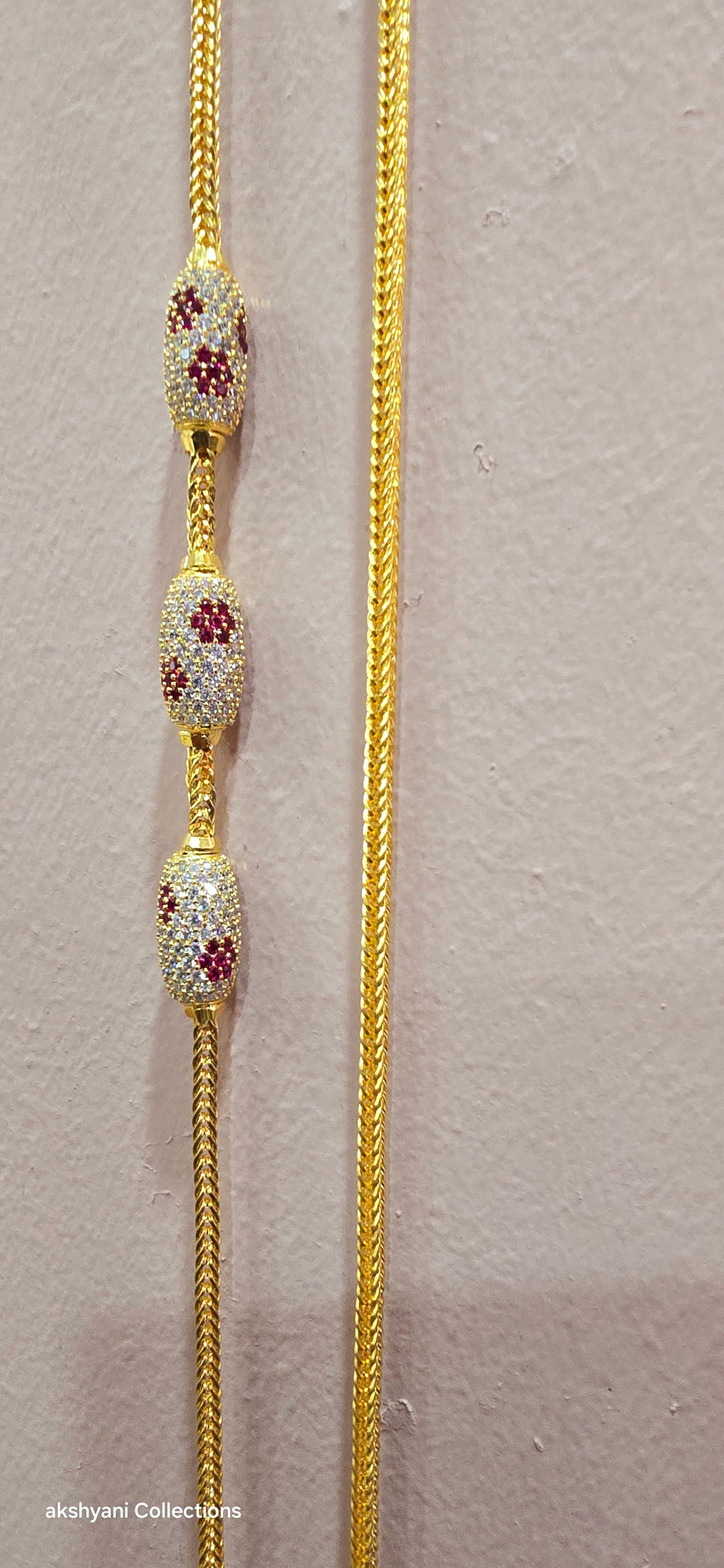 Ruby red with white pawprint mossanite stones Dailywear type thalikodi.  Not 916 gold