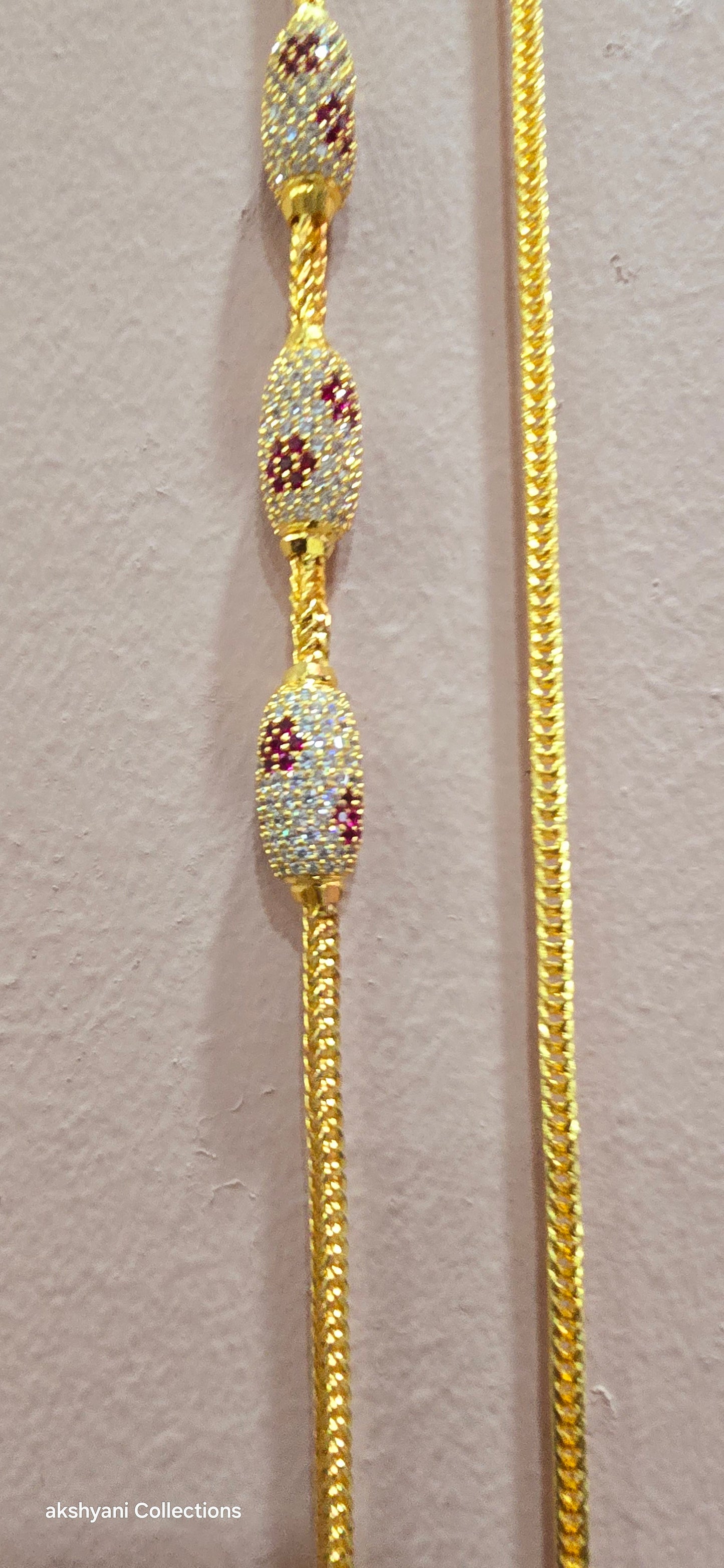 Ruby red with white pawprint mossanite stones Dailywear type thalikodi.  Not 916 gold