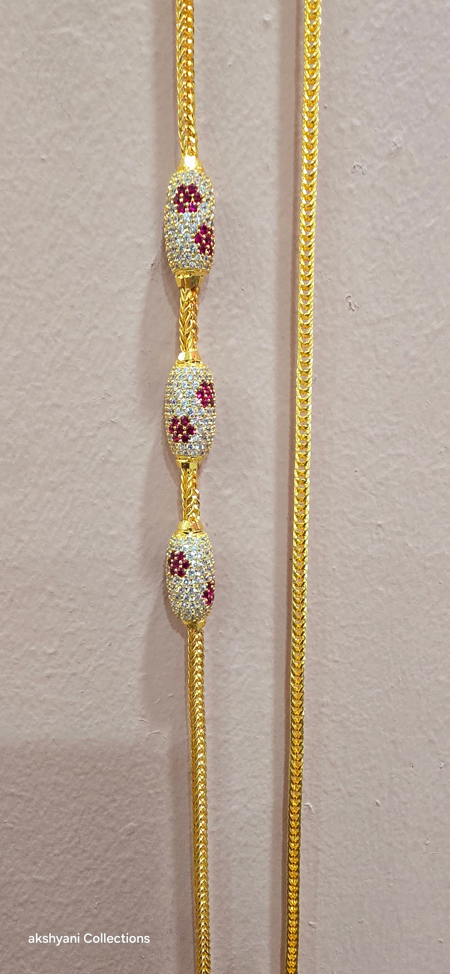 Ruby red with white pawprint mossanite stones Dailywear type thalikodi.  Not 916 gold