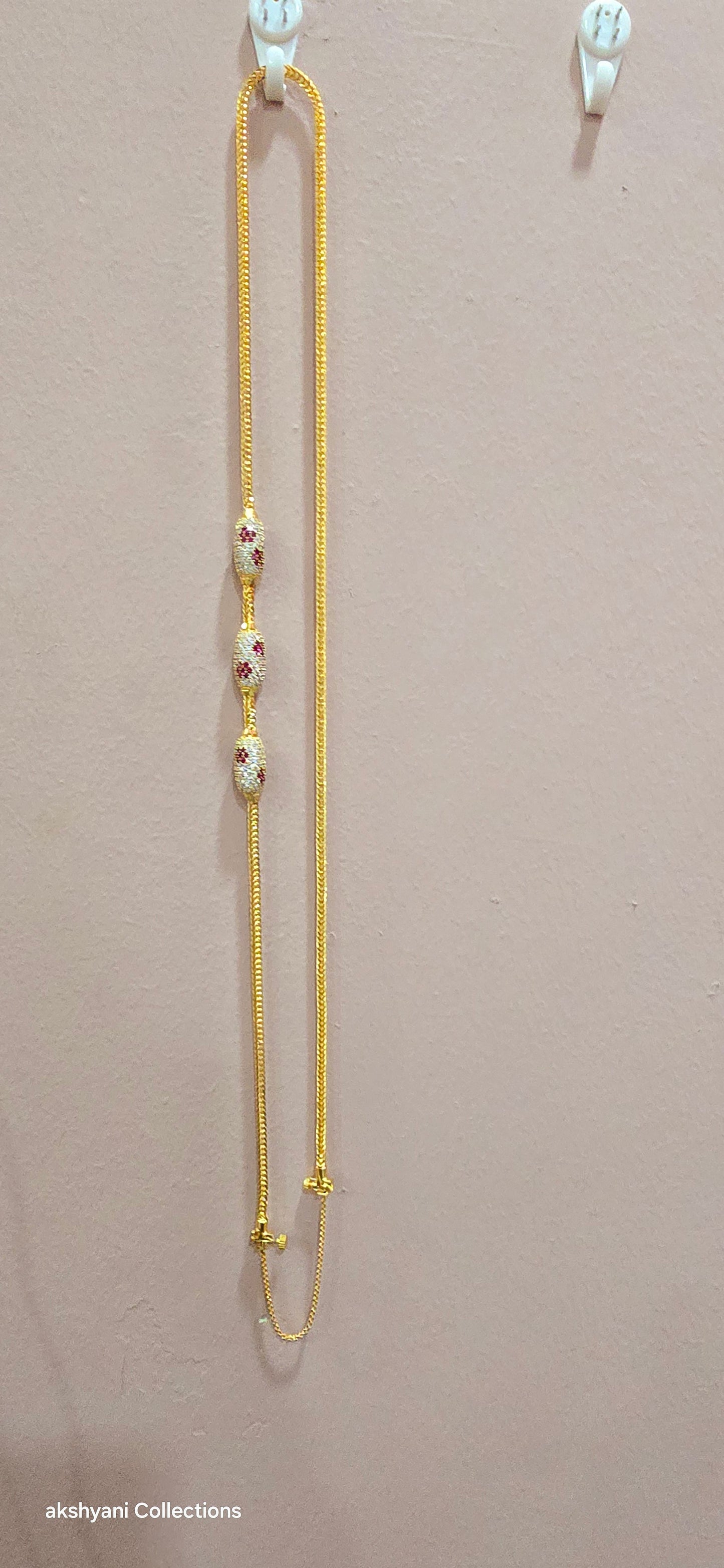 Ruby red with white pawprint mossanite stones Dailywear type thalikodi.  Not 916 gold