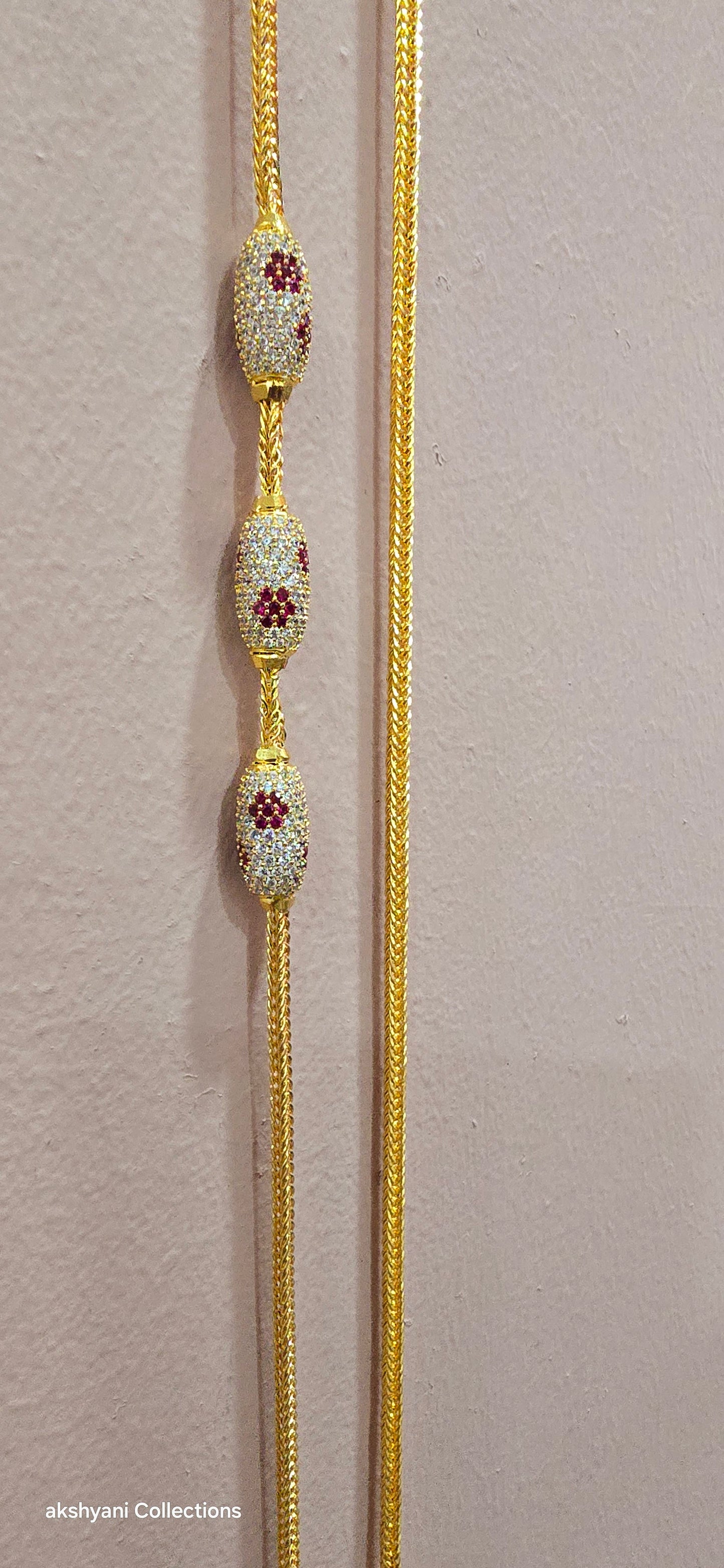 Ruby red with white pawprint mossanite stones Dailywear type thalikodi.  Not 916 gold