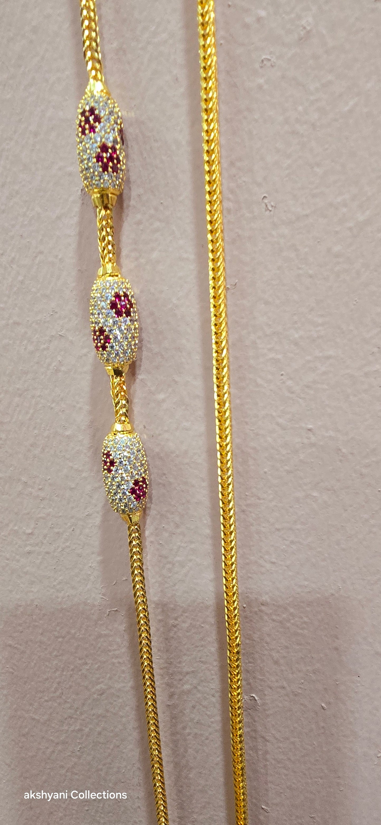 Ruby red with white pawprint mossanite stones Dailywear type thalikodi.  Not 916 gold