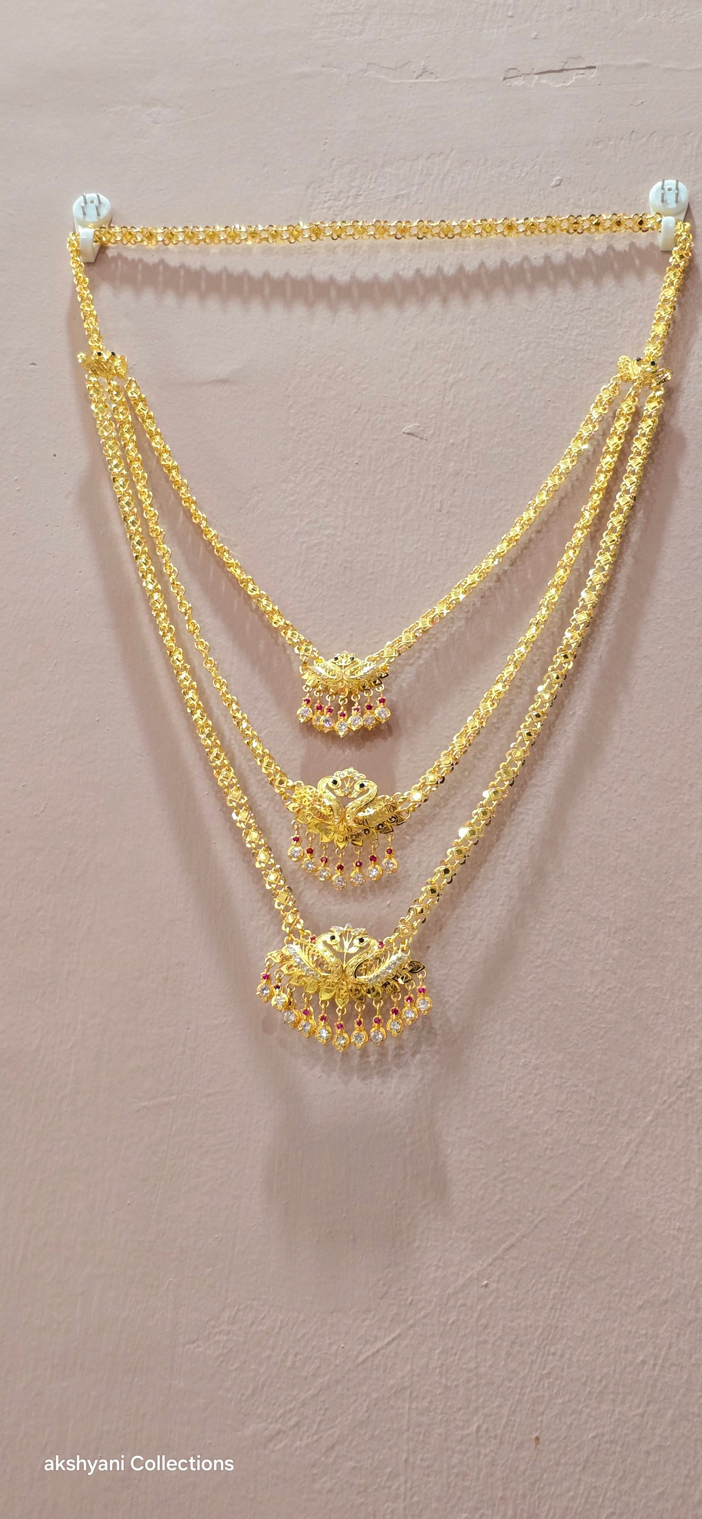 3 layer pendent chain not 916 gold. 28 inches length with decked peacock brooch. Code 808A.