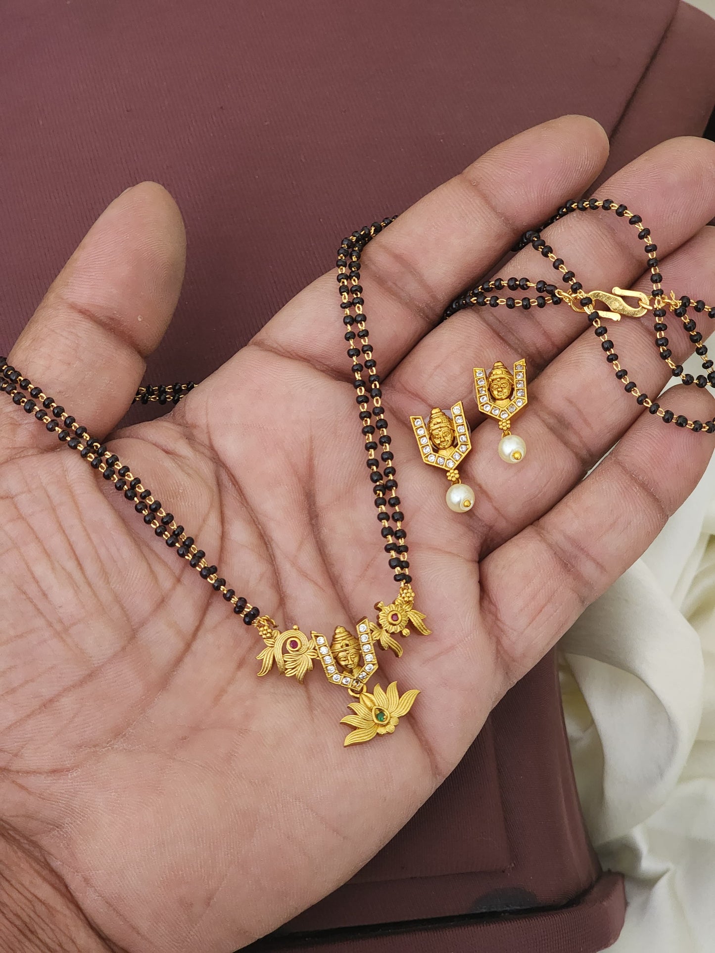 Black beads tirupathi locket with earrings.  Fashion wear. Not gold